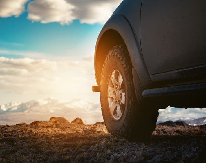 Driver's side tire on truck while on rocky terrain.