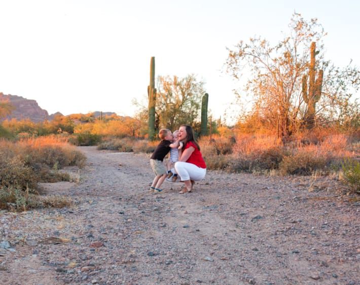 Family hugging on a desert road