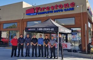Firestone Complete Auto Care crew standing in front of store