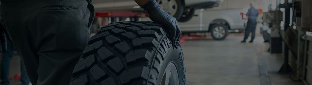 Firestone technician Gary standing at the front desk of the shop