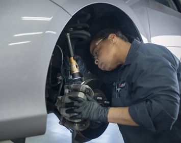 Firestone tech Debra checks brake components