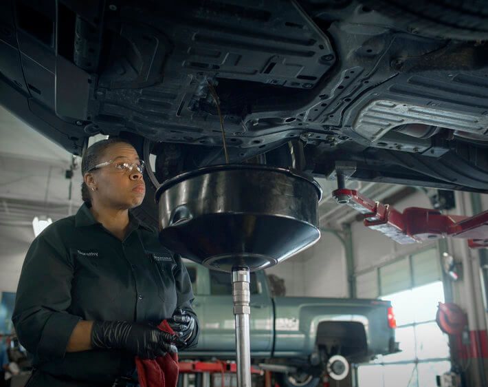 Firestone technician Debra changing oil