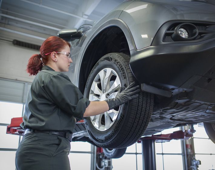 Woman working on a tire