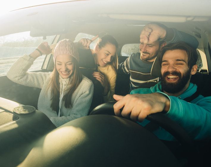 Friends laughing in a car