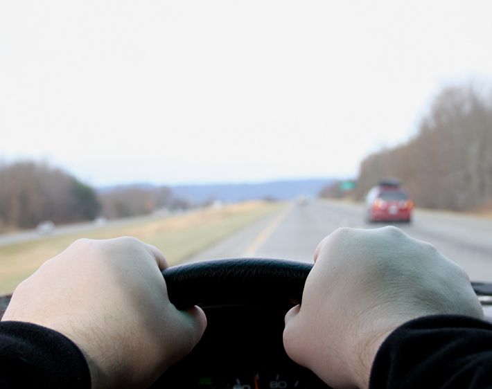 Hands gripping a steering wheel