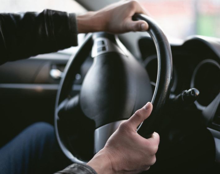 Hands turning a steering wheel