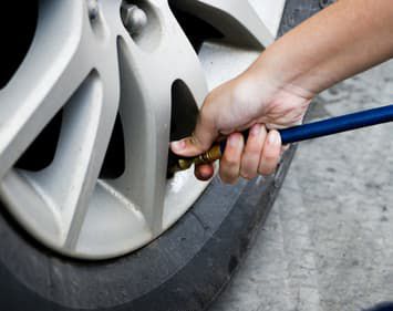 Person inflating flat tire