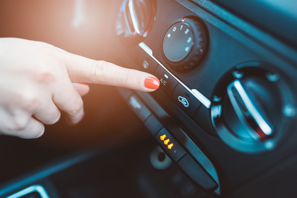 Woman trying to turn on her car's A/C