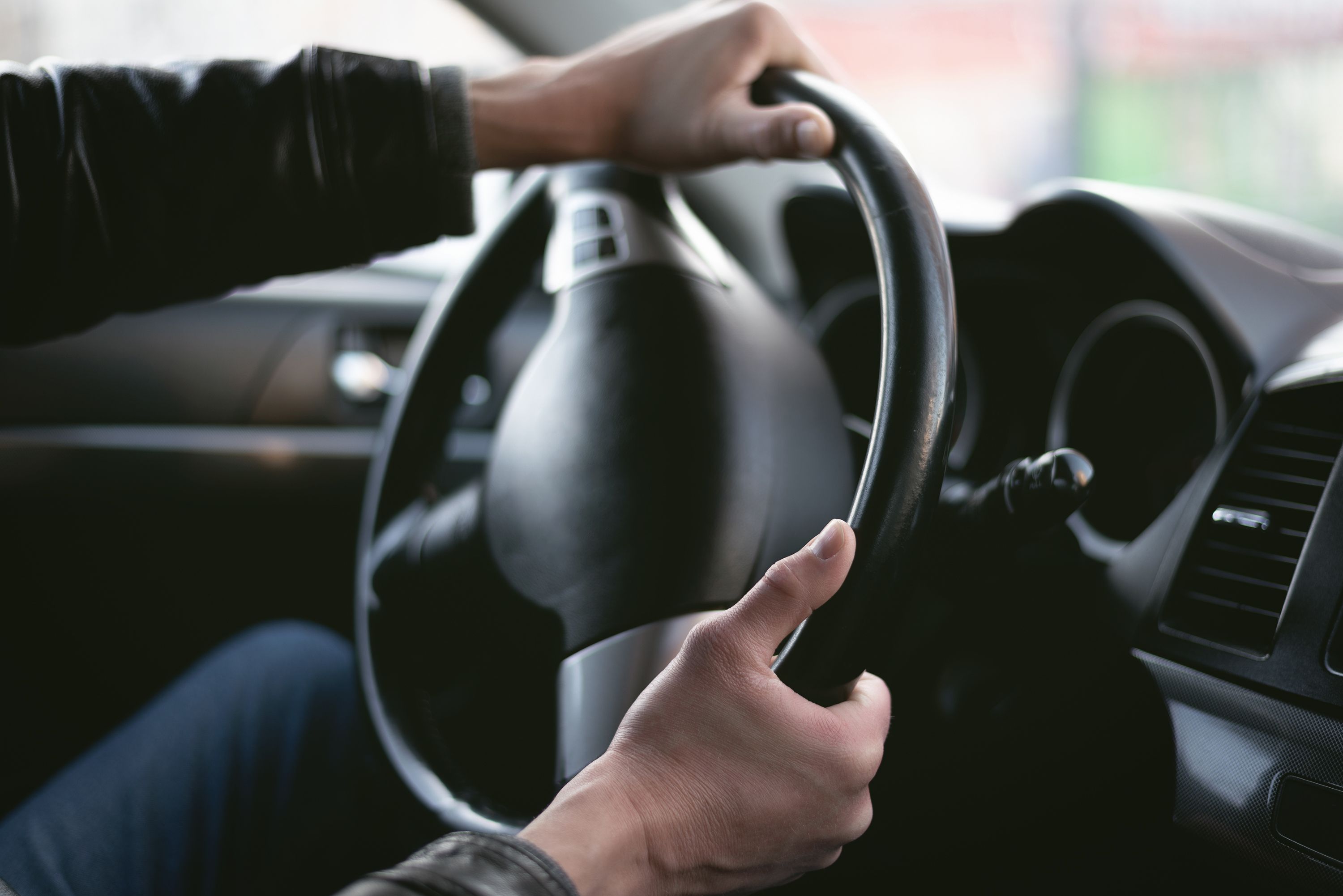men holding steering wheel