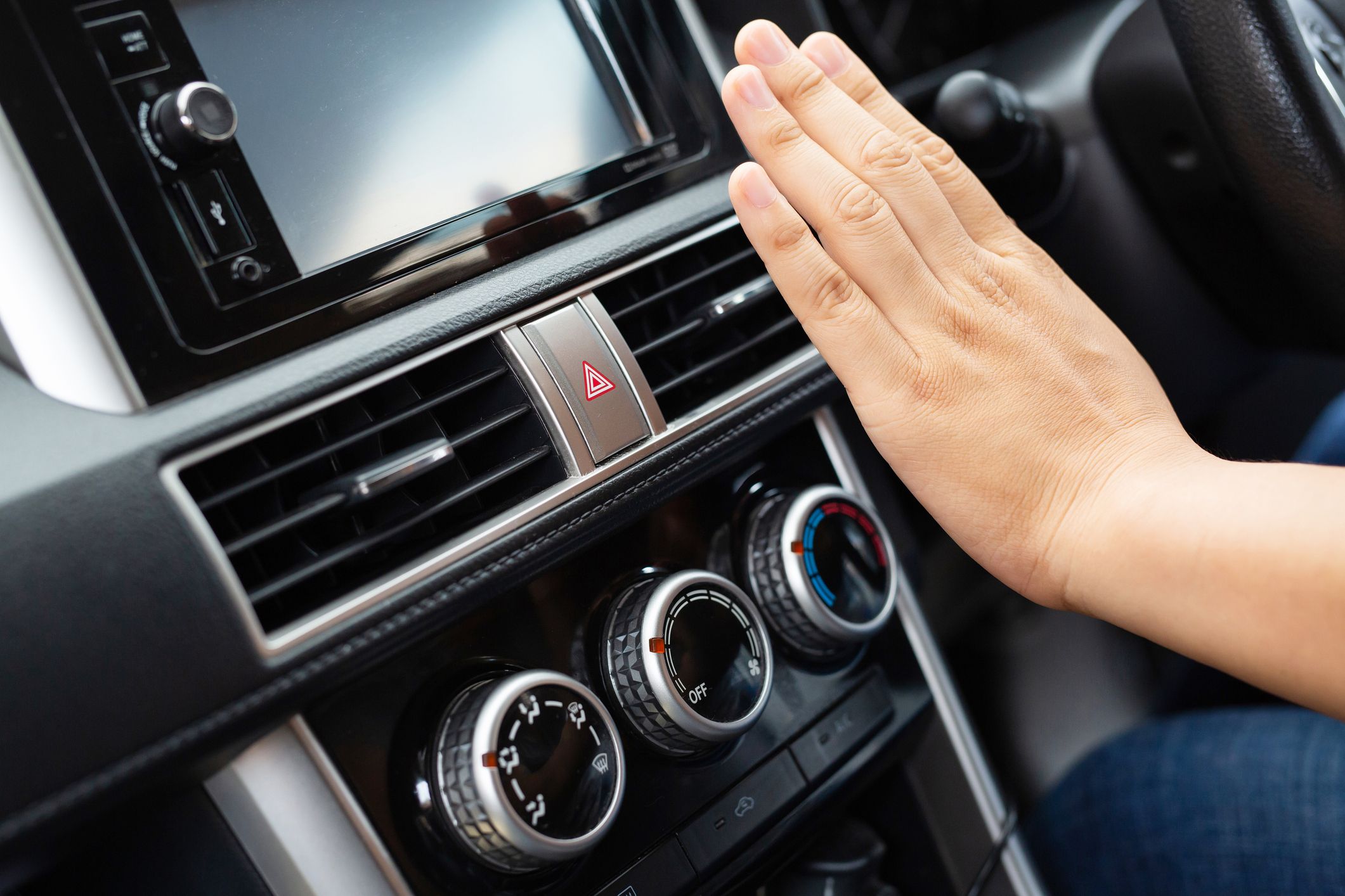 person with hand in the car cooling control