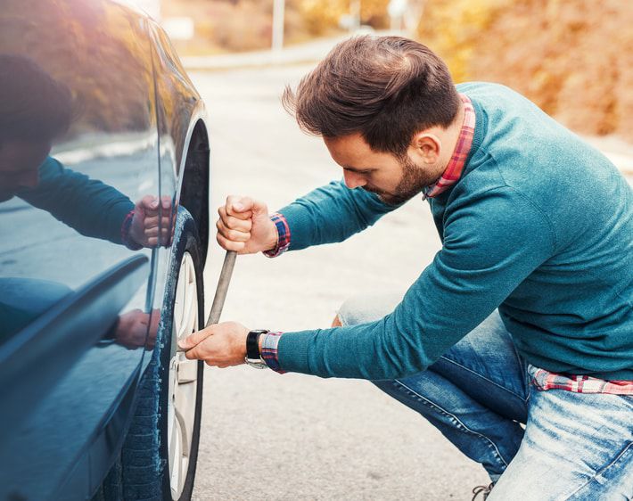 Man changing a flat tire