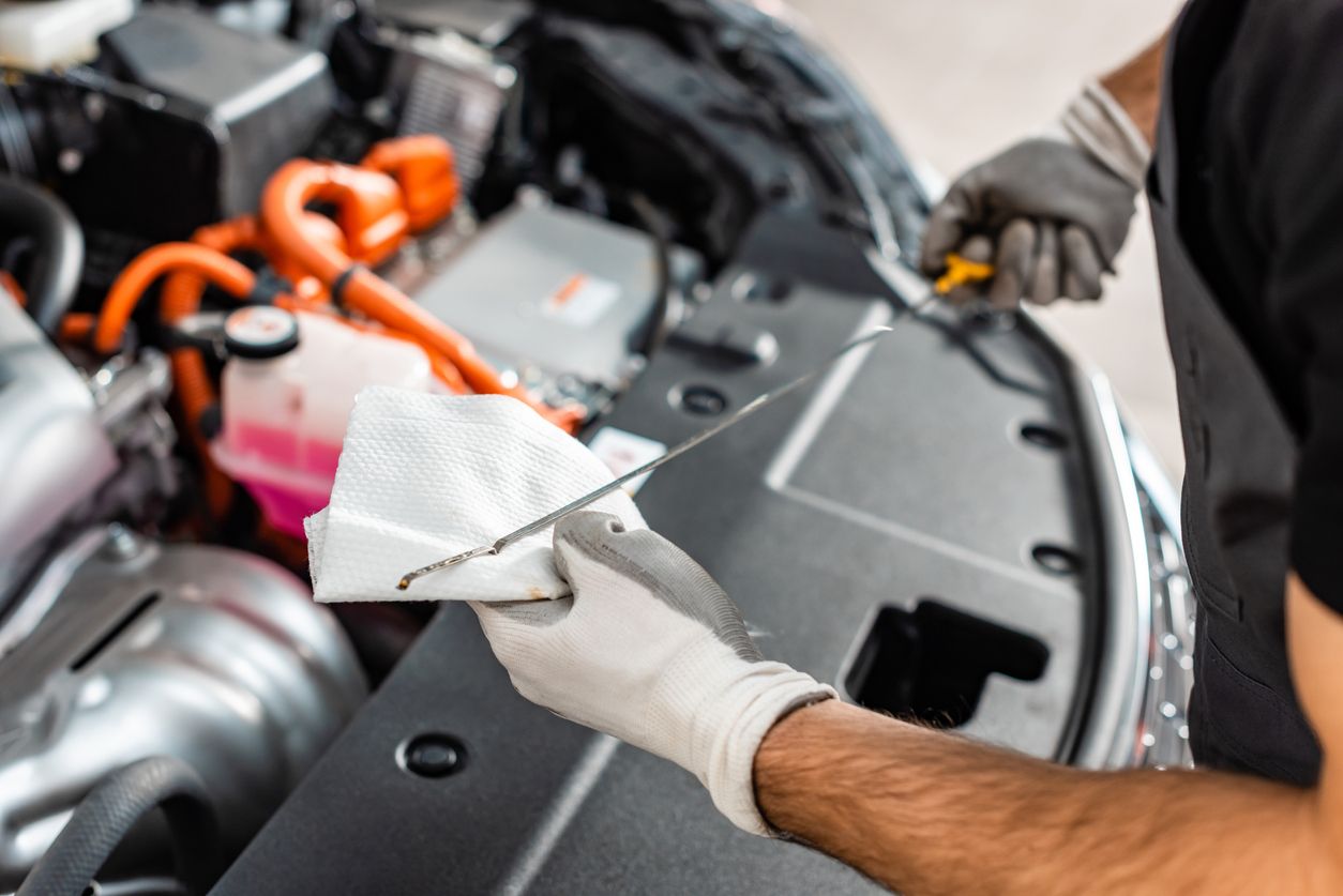 image of a man checking a dipstick