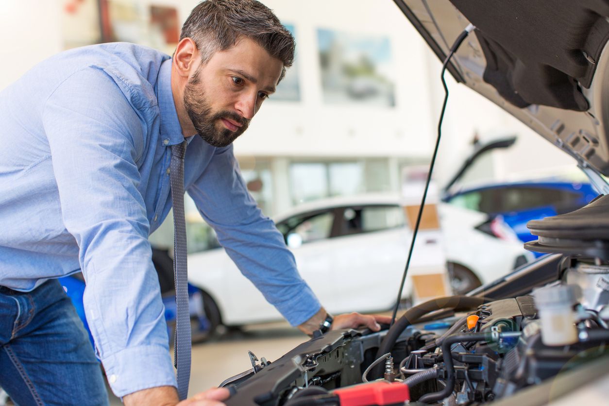 Technician changing car battery