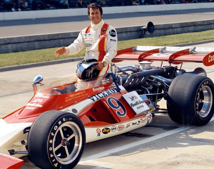 Mario Andretti with race car at the Indianapolis Speedway in 1972