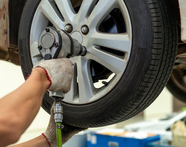 mechanic removing a tire for rotation