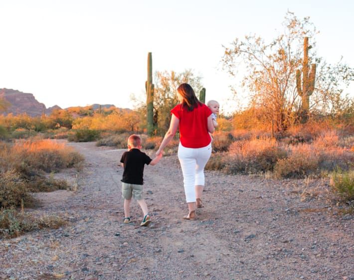 Mom and kids walking on a desert road