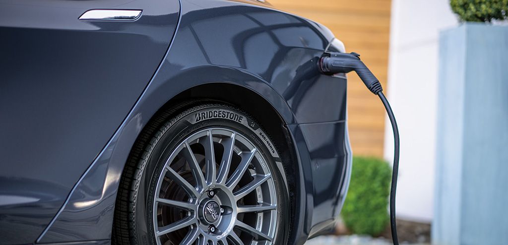 close up image of an electric vehicle with turanza ev tires, being charging