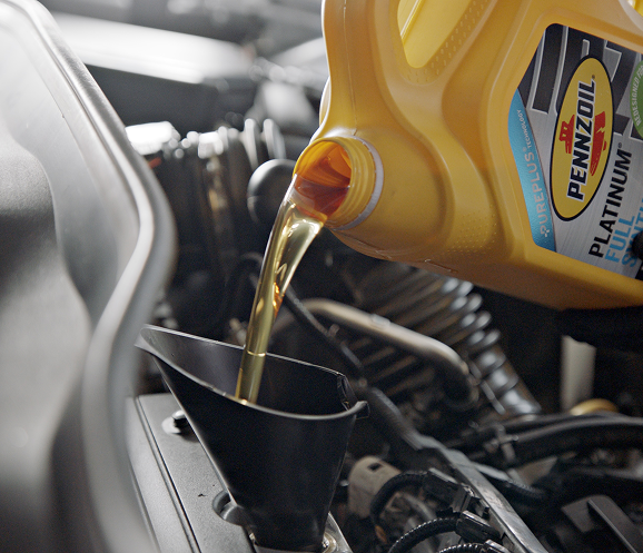 a close up of oil pouring from a container