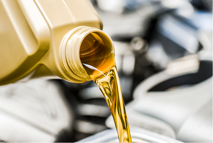 Motor oil being poured into a vehicle engine.