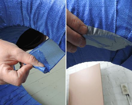 Close-up of securing blue ribbon to tire with duct tape