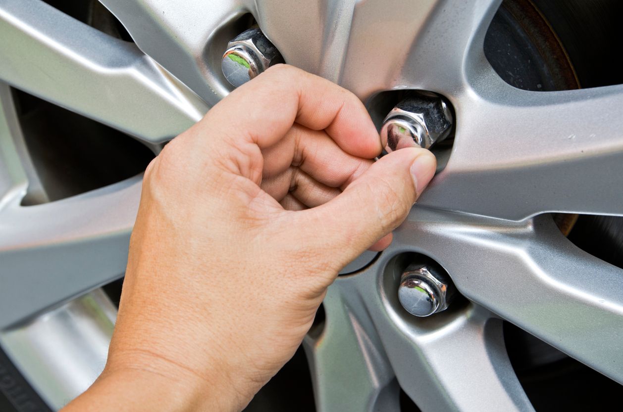 image of hand replacing a tire nut
