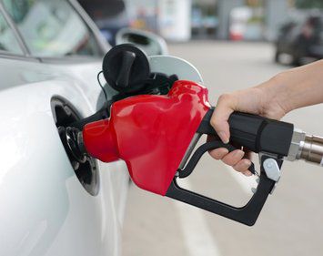 hand pumping gas refueling at gas station