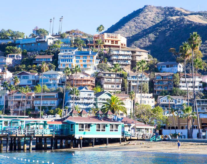 southern california beachfront vista with multi-colored houses and mountain