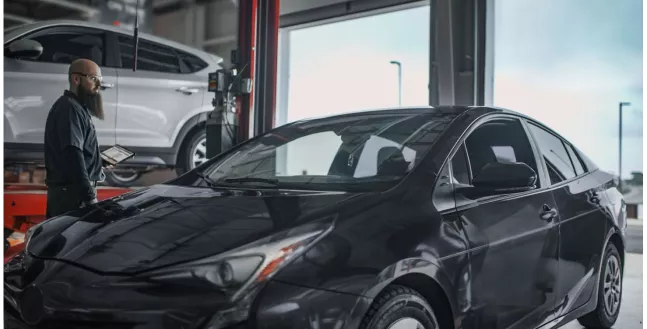 A technician inspecting a vehicle