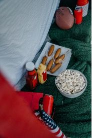 Corn dogs and a bowl of popcorn