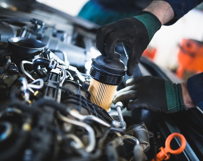 mechanic changing vehicle filter