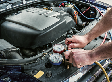 A technician checking a radiator with guages.