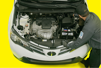 An auto technician reviewing vehicle inspection details on a tablet.
