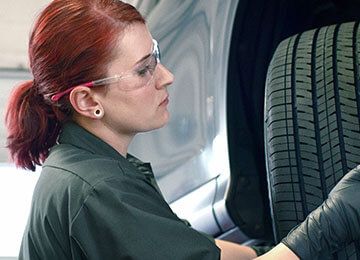 Firestone technician Brianna changing a tire