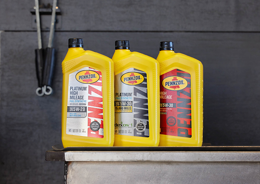 Three containers of Pennzoil high mileage and platinum full synthetic oil.