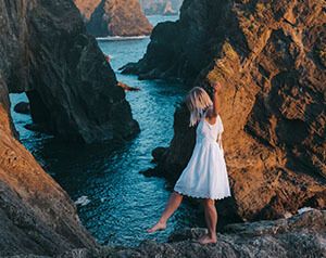 Blogger Alizah walking along the rocky West Coast