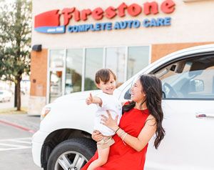 guest blogger Annie with her child in front of Firestone Complete Auto Care