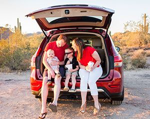 Family sitting in back of car