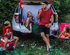 Family tailgating in the back of an SUV