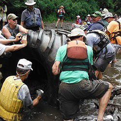 Volunteers pulling tires out of riverbed