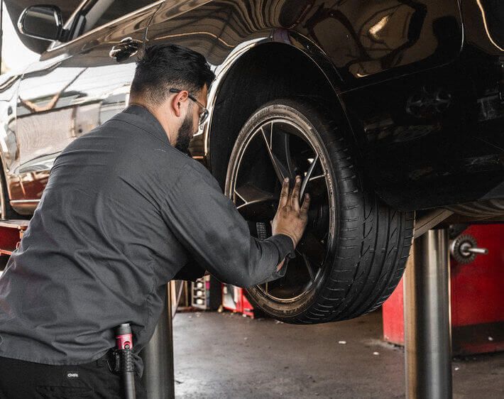 image of mechanic performing tire rotation