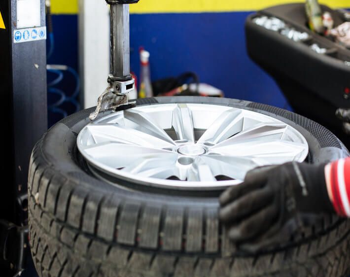 Machine taking a tire off of a rim, getting ready for tire rotation