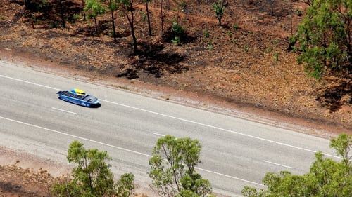 Blue solar car on the highway