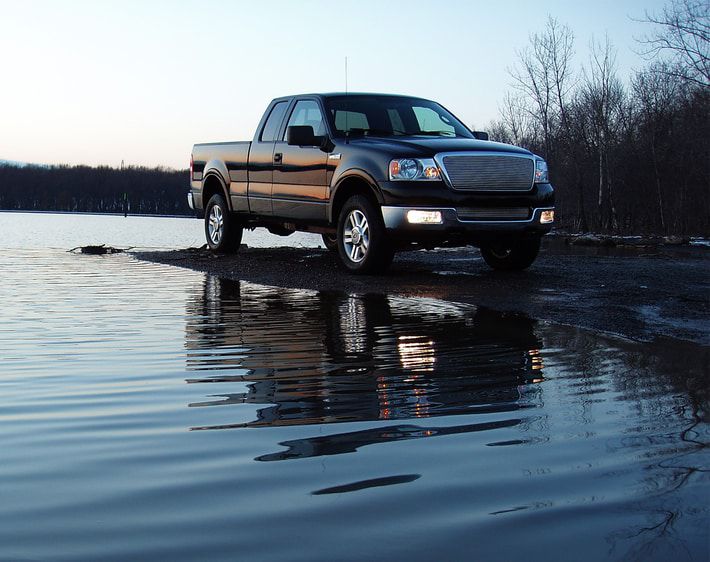 Truck parked next to a lake