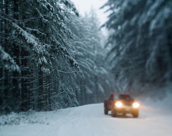 Truck driving through a snow storm