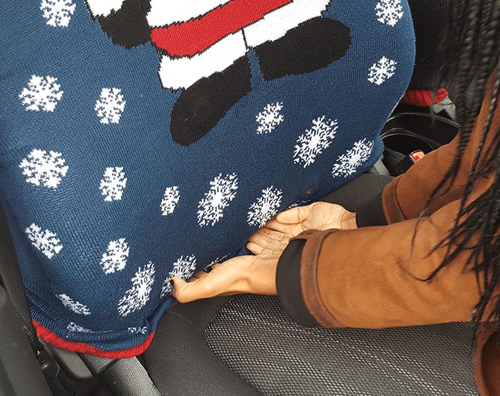 Tucking sweater into cushion of car seat