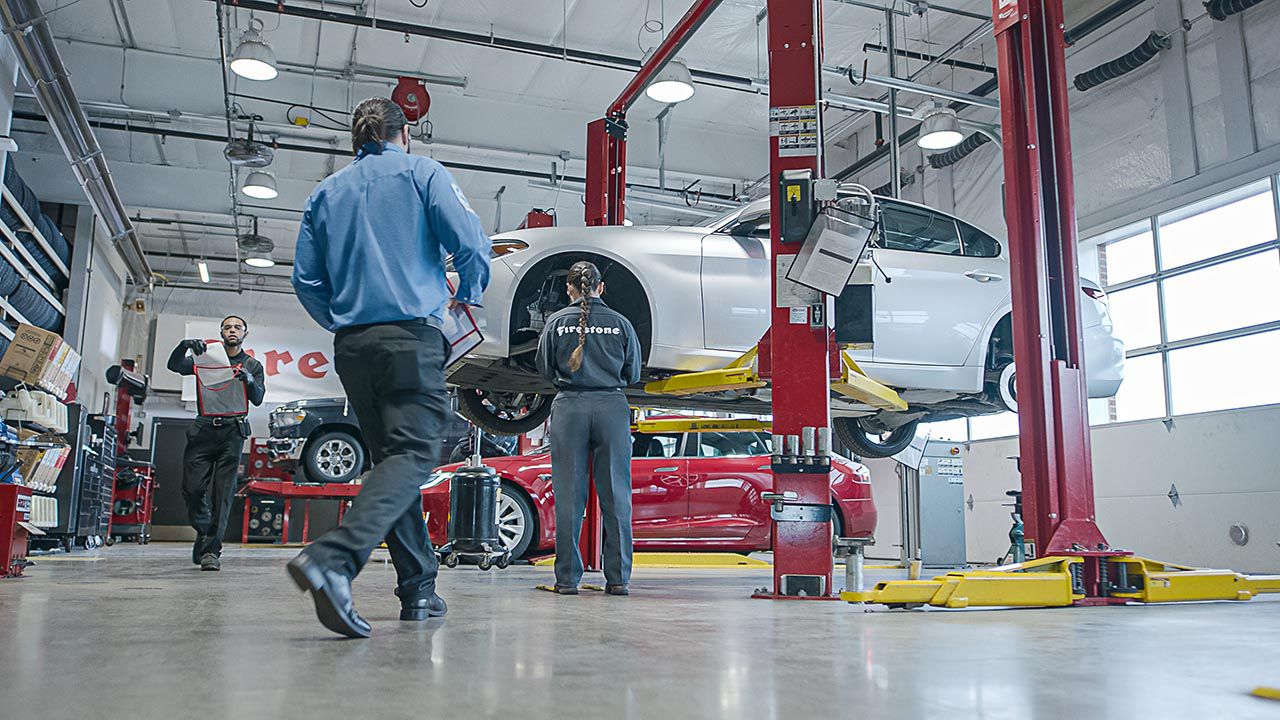 Firestone automotive technician working on car