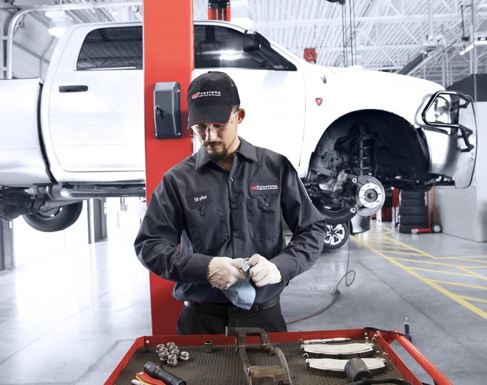 Firestone technician fixing brakes