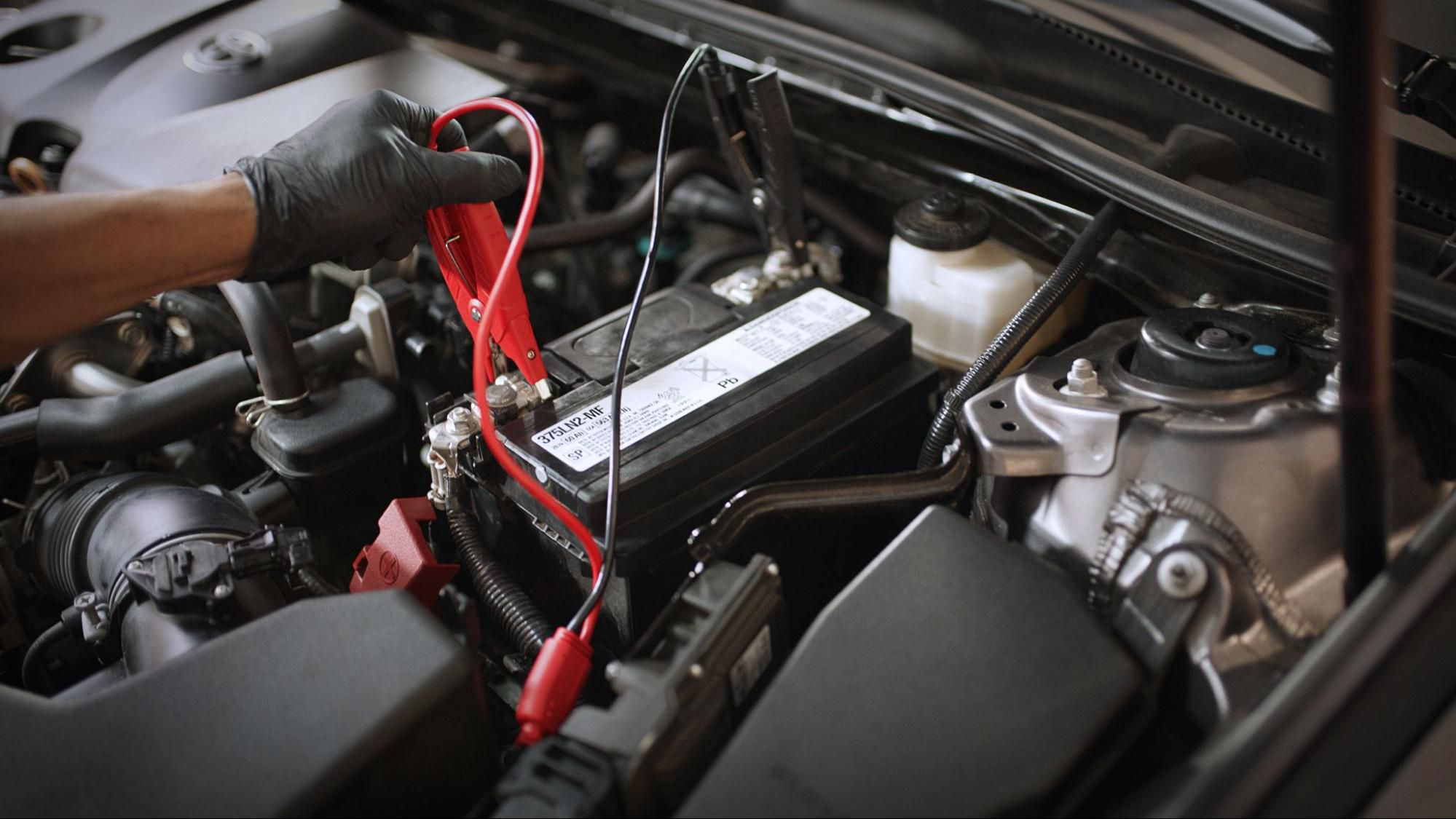 Woman with a car with a battery problem