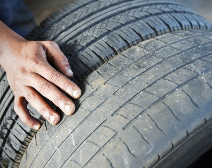 Person feeling a worn down tire