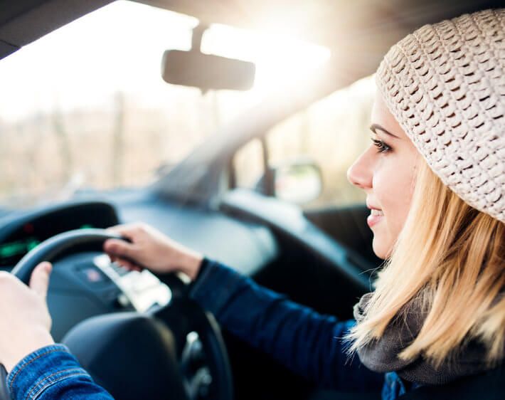 Young woman driving a Toyota Corolla in winter